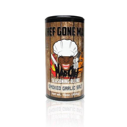 Chef Gone Mad Smoked Garlic Salt Seasoning Blend, a 16 oz. all-purpose seasoning featuring Sea Salt, Smoked Garlic, and a rich mix of herbs and spices like Basil, Rosemary, and Thyme. Perfect for salt lovers and fans of smoked garlic, this MSG-free blend adds bold flavor to daily dishes and secret recipes, with a smoky garlic aroma and rustic wood-textured packaging.